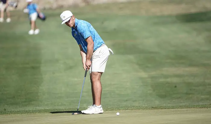 Golfer hitting ball