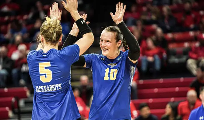 Two women high-fiving